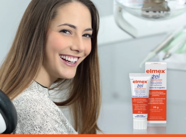  Young female technician looking into microscope in medical laboratory